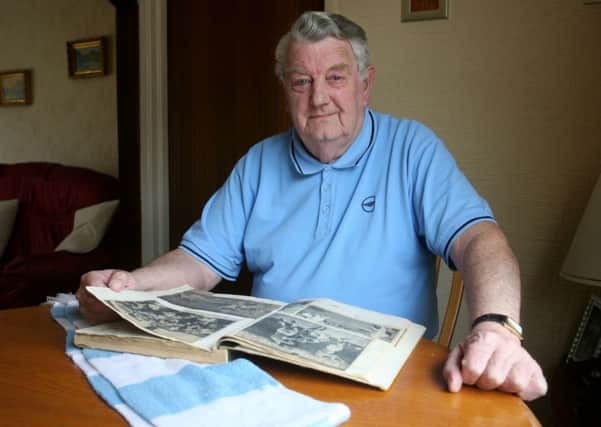 Maurice Millar looking over his Ballymena United Irish Cup scrap book. INBT16-215AC