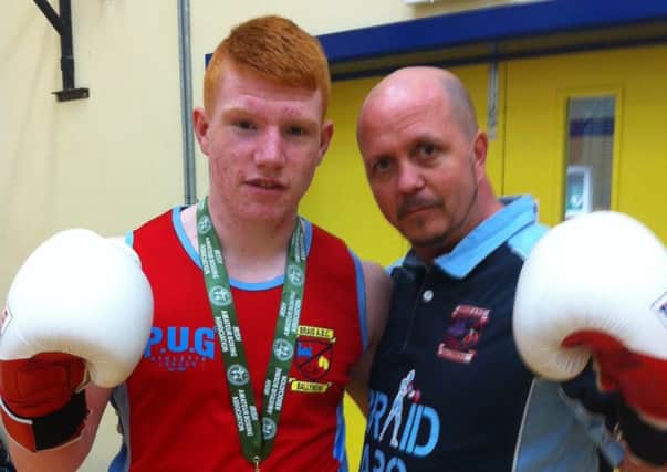 Jacob Bradshaw pictured with his Irish silver medal and Braid ABC coach Sean O`Boyle.