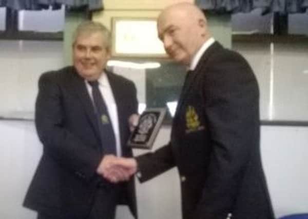 Incoming Lambeg Golf Club Captain, John Greeran presents outgoing Captain Ritchie Gorman with commemorative plaque.