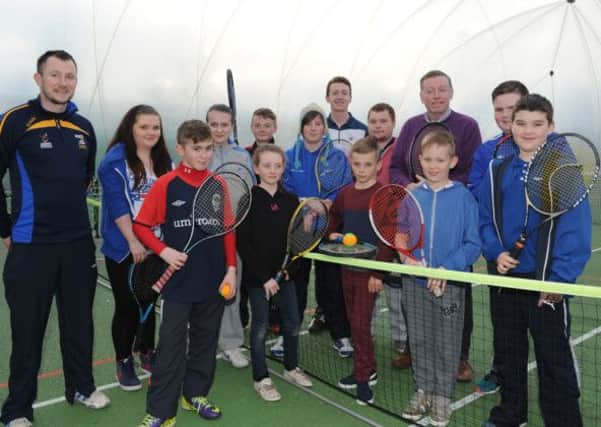 Alderman Paul Porter, Chairman of the Council's Leisure Services Committee is pictured with the young people from Old Warren who are taking part in a council led tennis initiative in Wallace Park organised by Kevin Madden, Sports Development Officer (also pictured).