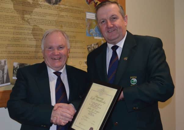 Outgoing Captain Mr George Fitzpatrick presenting Honorary Life Membership of Foyle Golf Club to John J Logue.