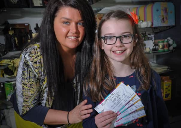 Mary McKeown, Tourism manager with Cookstown Council presenting Ella Neeson, with family tickets to Indigo Moons Jungle Book at the Burnavon on Thursday 22nd May.