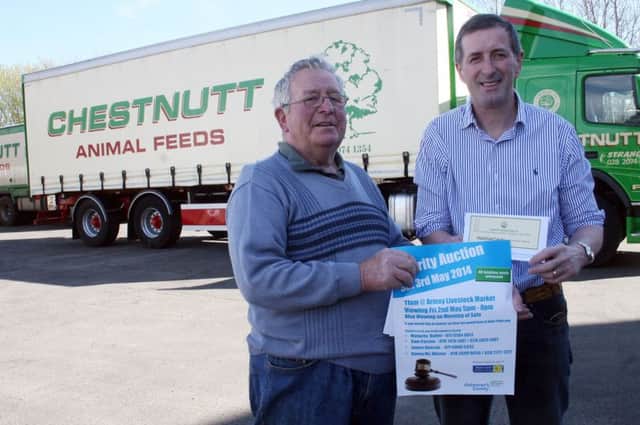 Mr James Chestnutt (right) from Chestnutt Animal Feeds, Stranocum, presents Stanley Jamison, chair of the Moyle District branch of Marie Curie with four vouchers each for £300 to be auctioned at Armoy Livestock Market on Sturday, May 3. The charity event will raise money for Marie Curie Cancer Care and the Alzheimer's Society.Pic supplied