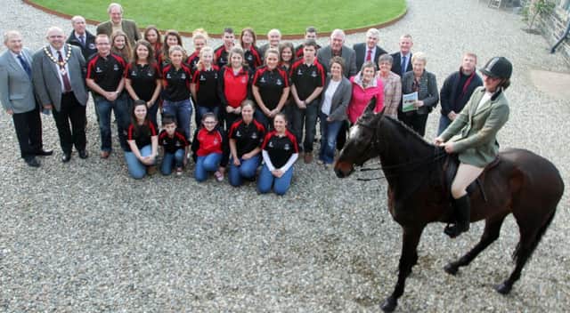 NEIGH BOTHER. Sponsors, Stewards and members from Kilraughts YFC, pictured along with Melanie Moorhead on her horse, 'Irish Twang' promoting the Horse & Pony Section at the Sponsors launch of the Ballymoney Show on Monday night at Lissannoure Castle. Included is Mayor Cllr John Finlay representing main sponsor Ballymoney Council.INBM18-14 008SC.