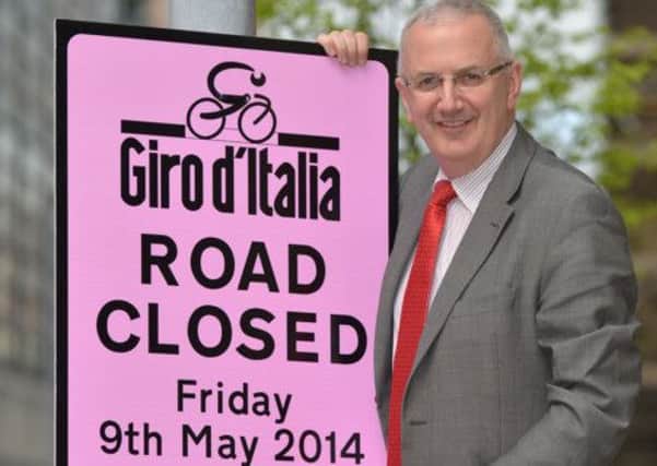 Transport Minister Danny Kennedy is urging people to use public transport as he puts up the first of 1700 posters along the Giro dItalia route which goes through Belfast, Ballymena, Ballymoney, Giants Causeway,  down the Antrim coast, Larne, Belfast City Hall through Armagh before going to Dublin,  to warn people of road closures during the world cycling event which is expected to attract 140,000 spectators. photo by Aaron McCracken/Harrisons