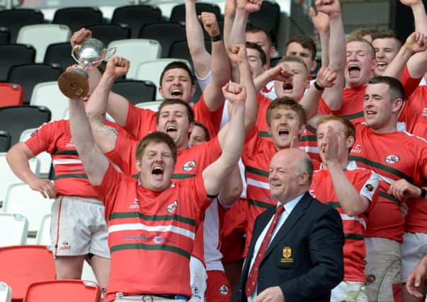 Larne Captain James McCluggage lifts the Gordon West Cup aloft after the victory over Holywood at Holywood. INLT 17-379-PR