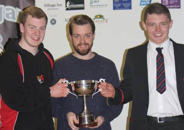 Richard Clarke presents the Gary Clarke Memorial Cup to Banbridge Academy and Lurgan College winning captains.