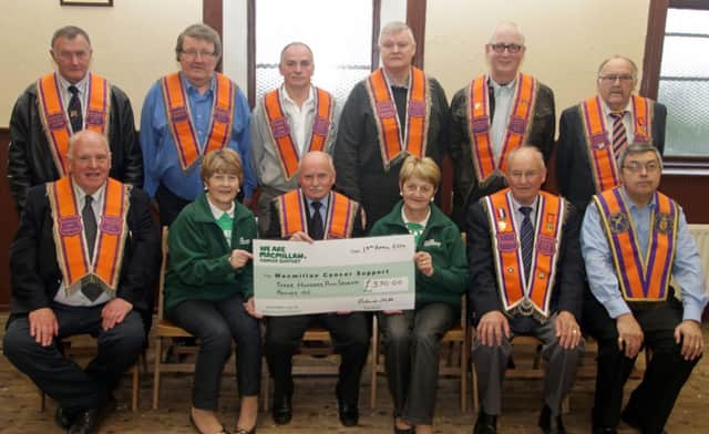 COMMITTEE CHEQUE. Bro William Archibald, Chairman of the North Antrim Amalgamated Orange Committee, pictured on Saturday night at Drumcon Orange Hall presenting a cheque for £370.00 to Barbara Logan and Anna White from the Causeway Branch of Macmillan Cancer Support Group. The money was raised at a Church Service and looking on along with Treasurer, Bro Roland Hill, Chaplain Bro John Gault and Secretary Bro John McGregor are committee members.INBM19-14 040SC.