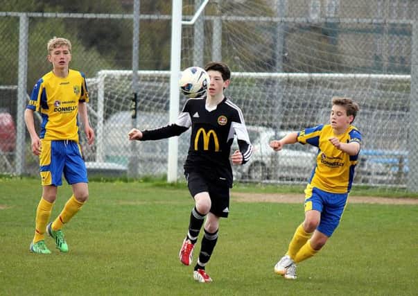 A Carniny Youth under-14 player shows good close control during Saturday's match against Dungannon. INBT 18-902H