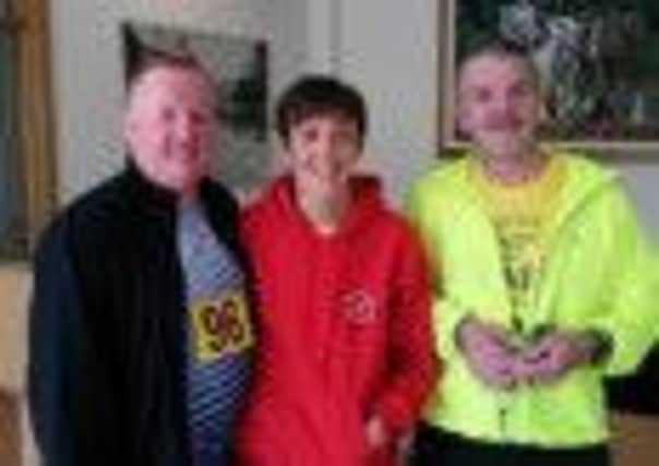 Larne Athletic Club's Heather Baxter with Jim Evans and Colin Baxter after the Ballynahinch 10k.
