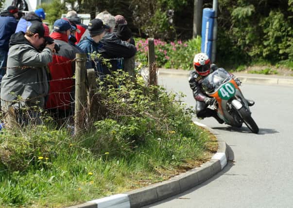 The crowd get a close look at Barry Davidson on his way to third place in the 250 Classic race. Picture: Roy Adams.