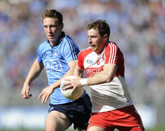 Derry's Gerard O'Kane and Kevin Nolan of Dublin. ©INPHO/Tommy Grealy