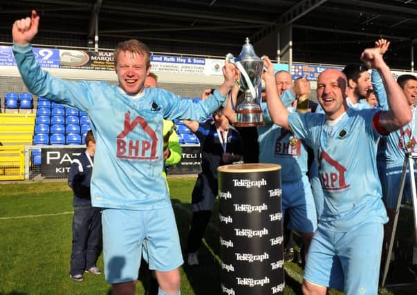 Institute's Graham Crown (left) and Paddy McLaughlin hold aloft the Championship One trophy.