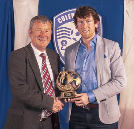 Hugh Wade presents the Player of the Year trophy to  Howard Beverland.