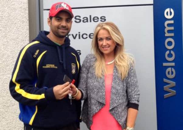 Donemana cricket professional Kammy Sajid receiving the keys for his sponsored car from McGillion Motors Sion Mills.