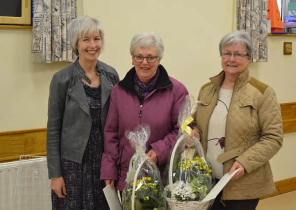 Tracey Mcllwaine presents fellow Gleno WI members Dorothy McIlroy and Marbeth Mark with bouquets for their golden wedding anniversaries. INLT 180641-CON