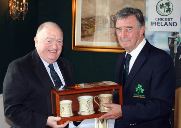 Cricket Ireland President Joe Doherty (left) receives the ceremonial Staffordshire mugs from outgoing President Robin Walsh.