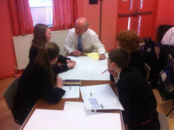 Business volunteer Alan Hunter working with Carrickfergus Grammar School students.