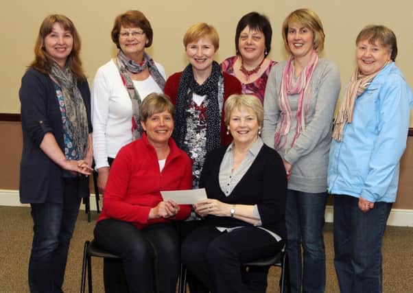 Mrs. Dorothy Black, seated right, of Coleraine NI Hospice Support Group is presented with a £500 cheque from Fit for Life organisers and committee members at St. Patrick's Church Hall. Included are, Shirley Taylor, presenting the cheque, Diane McDowell, Rena Lindsay, Alison Wallace, Julie McGaw, Jane Richmond and Fay Moore. INCR19-102PL