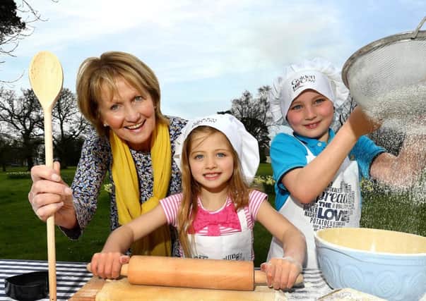 To celebrate spreading the love of baking from generation to generation, Jenny Bristow has developed some delicious buttery recipes for all the family to enjoy which are available with special 500g Golden Cow Easispread tubs. Pictured with Jenny Bristow are brother and sister Killian McCandless aged 7 and Emily McCandless aged 6.