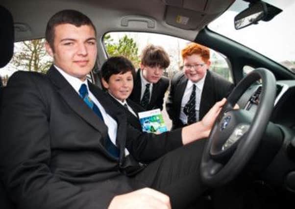 Carrick College Year 11 pupil Ryan Jeavons and Year 9 pupils Thomas Hermin, Lewis Hempton and Nathan Mann check out the e-car.  INCT 18-730-CON
