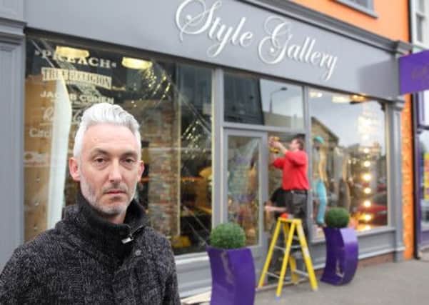 Dylan Hall from Style Gallery in Market Place pictured outside the designer clothes store as workmen start to repair damage to the front door and windows following a ram raid attack. US1418-616cd Picture: Cliff Donaldson