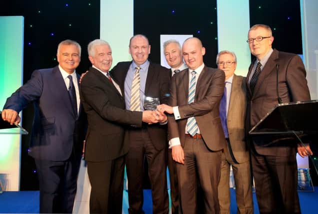 The team from Lindsay Ford Mallusk pictured at the Ford Retail Awards for Excellence with TV presenter Eamonn Holmes (left) and Stuart Kerr (second left), Ford Retail CEO. Pic by Paul Starr