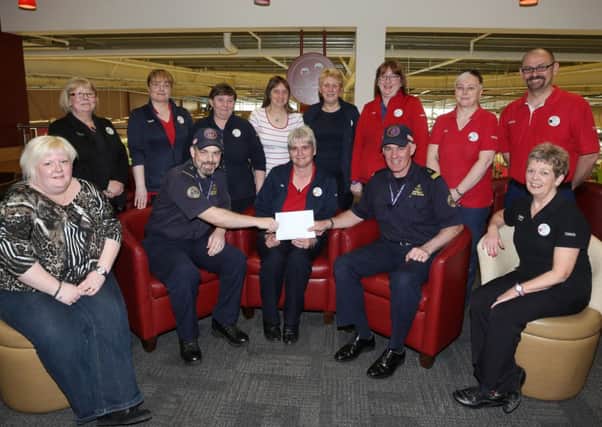 Tesco staff member Eileen Reid presents a cheque for £1620, which staff in the Ballymena raised through a store collection in memory of their former colleague Lizzie Greer, to Andrew Millar and Norman Worthington of the Community Rescue Service, Portglenone. INBT 19-102JC