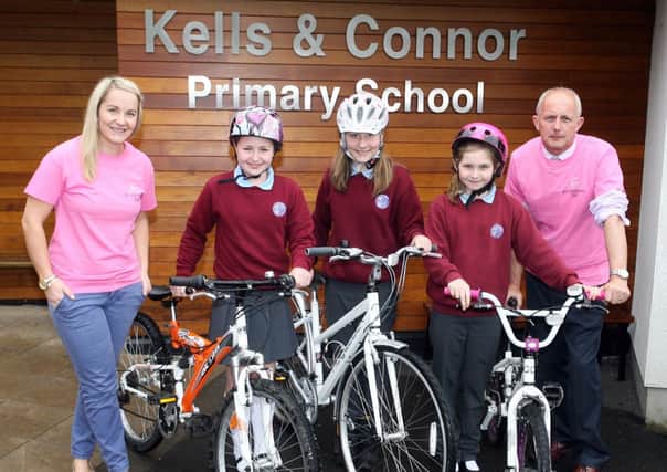 Kells and Connor PS pupils Lorre Nesbitt, Amy Cunningham and Ruth McDowell, along with principal Mr. Roy McClelland and Miss. Jill Bartley getting ready for their own "Giro" event in the school on Friday, May 9. To encourage healthy lifestyle and also raise funds, pupils are taking part in a sponsored bike event in the school. The party in pink will last all day and will involve different events on the cycling theme. INBT19-204AC