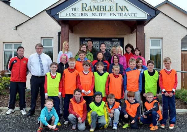 John McLarnon of the Ramble Inn; joins the boys and girls of Carniny Youth U-11 who took part with their friends and family on a sponsored walk to the Ramble Inn walk to raise funds for the team. INBT 19-806H