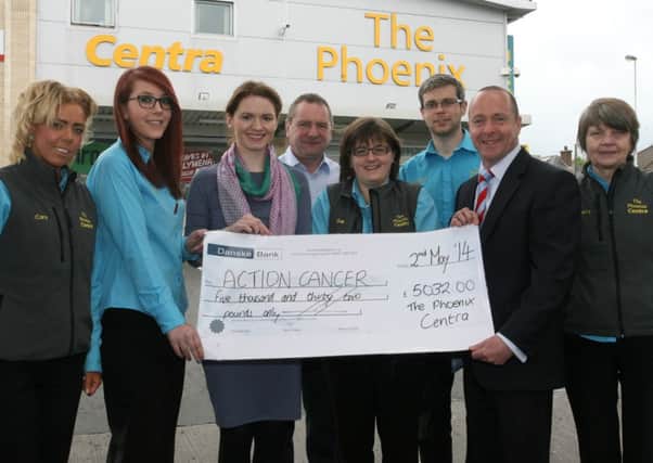 Peter McCool, Kevin Killough and staff from The Phoenix Centre presents a cheque for £5032 to Sinead Magill of Action Cancer. The money was raised through various fundraising activities including the Causeway Walk, sponsored cycle ride and fancy dress days. INBT19-214AC