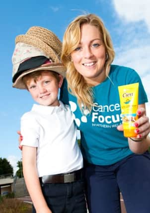 Finbar Mallon (7) gets a few tips from Niamh McDaid, Cancer Focus Northern Ireland, about staying safe in the sun as the summer approaches. INBM19-14