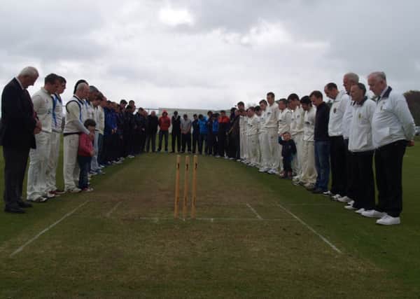 Teams from Ardmore, Newbuildings, Donemana and Coleraine along with umpires and officials from the Derry Mid-week League, pictured during the minute silence in memory of Sam McConnell.