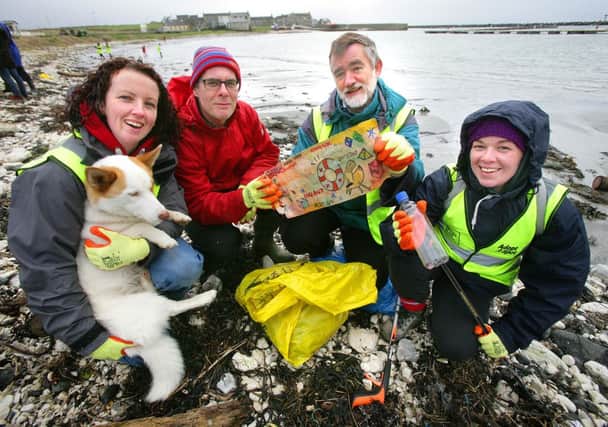 Tania McFaul (and Brodie the dog), Jonathan Mitchell, David Quinney-Mee and Aisling Gribbin (Keep Northern Ireland Beautiful). With the message in the bottle that was found on Church Bay Beach. INBM19-14