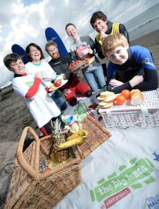 Autism Initiatives NI is encouraging people across the North Coast to get together and have a Big Lunch with their neighbours and friends this June. Pictured at their Easter Surf Programme at West Strand, Portrush (from left): Joe McCloskey from Glenariff, local Big Lunch representative Grainne McCloskey with big-wave surfer Al Mennie, Pauline Graham, Health & Activity Co-ordinator for Autism Initiatives NI, Ricky Martin from Alive Surf School and Jonny Holmes from Belfast. For more information about holding a Big Lunch, request a free pack online at www.thebiglunch.com