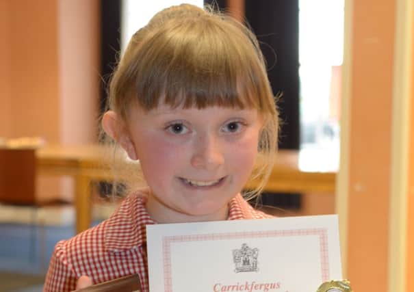 Abbie Grey from Eden P.S. with her trophy and certificate for first place in the 8 years bible speaking section at the Carrickfergus Music Festival. INCT 19-329-PR