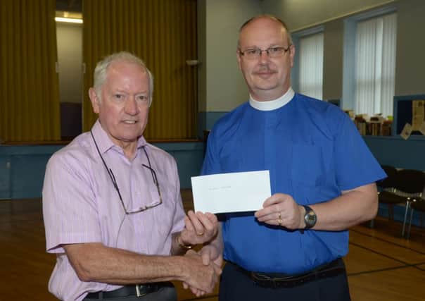 Austin Jenkins hands over a cheque, raised at the Lenten lunches, to Rev Mark Taylor for Church of Ireland Summer Madness. INCT 19-380-PR