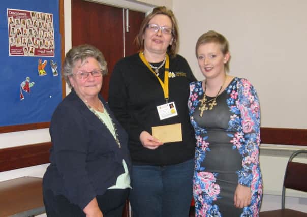 Coleraine W.I. President Kathleen Presha presents a cheque to Mollie Clarke and Heather Pollock, for the Childrens Cancer Fund for Northern Ireland, on behalf of the members. INCR20-114S