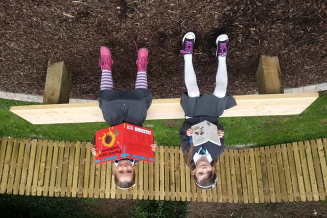 Some young pupils enjoying reading in their new classroom. INBM20-14