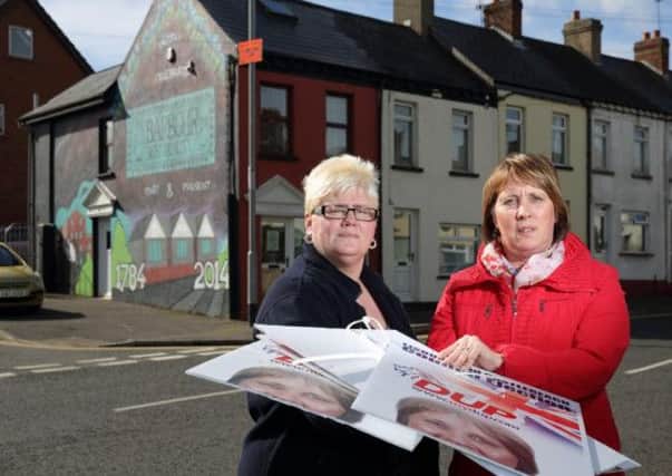 Trish McCormick, chair of Hilden Community Association, and Cllr Jenny Palmer with election posters that were taken down from lamp posts on Grand Street and cut up. US1419-528cd Picture: Cliff Donaldson