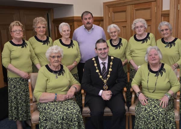 The Mayor, Councillor Martin Reilly, pictured with members of the Waterside based cross-community Harmony Singers choir who enjoyed a recent visit to the Mayor's Parlour in the Guildhall. INLS1214-117KM
