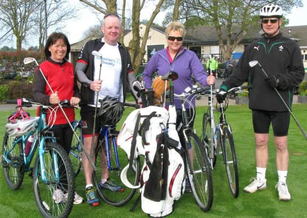 Rosie McCrea, Ed Donaldson, Patricia McDonnell and Colin McClenaghan checking their golf clubs on the first tee before cycling to Newcastle in aid of Alzheimers.
