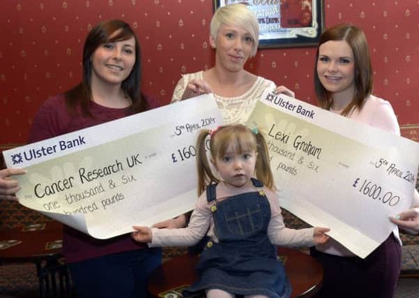 Coral Redpath and Zoe Bicker presented cheques totalling £3200:00, proceeds form a  Charity Pub Quiz and Sponsored Walk, to Heather Greer towards Lexi's Wheelchair Fund and Cancer Research UK included helping to hold the cheques is Lexi  © Edward Byrne Photography INBL19-200EB