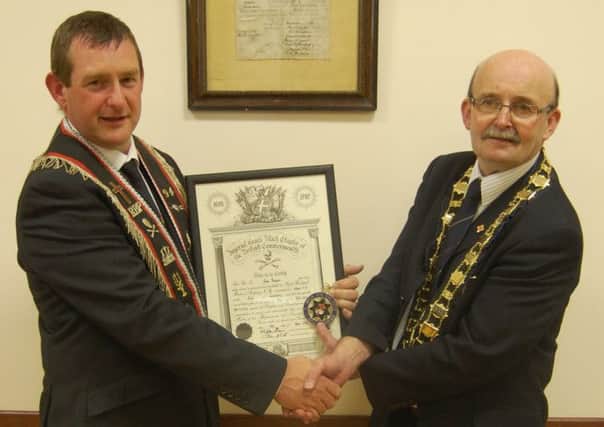 Outgoing Worshipful Master of Ballantine Heroes RBP No. 94, Sir Knt. David Thompson being presented by his certificate by the Co.  Londonderry Royal Black Chapter Worshipful Master and Assistant Sovereign Grand Master, Worshipful Sir Knt. Ivan Kelly.