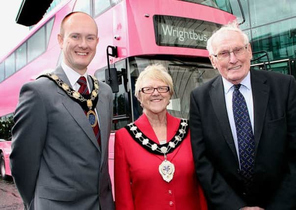 Its "pink" and proud ..... the Wright "pink" London bus outside the Braid Arts Centre last week for the Giro with Alan Stewart (Ballymena Chamber of Commerce), Ballymena Mayor Audrey Wales and William Wright (Wright Bus). INBT 20-805H