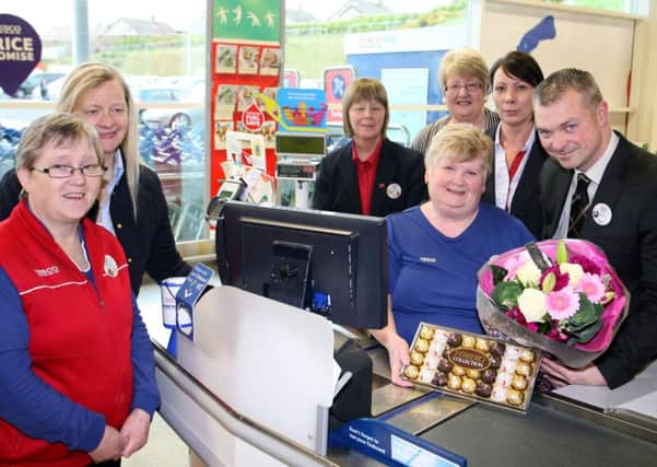 Mary Linton who retired from Tesco after 28 years of service is pictured receiving a gift from Ballymena store deputy manager Oliver Tallon. Included are Marys colleagues who wished her all the best for the future. INBT20-219AC