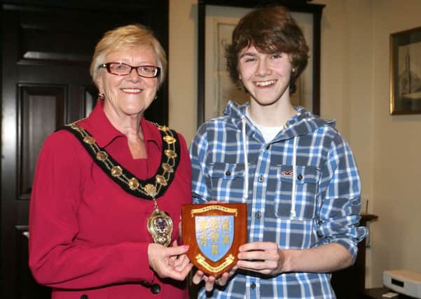 Mayor of Ballymena, Cllr. Audrey Wales, is pictured presenting a plaque to Kyle Bonnes, a fifth form student at the Ballymena Academy, who has been accepted into the Youth Music Theatre in London. INBT20-220AC