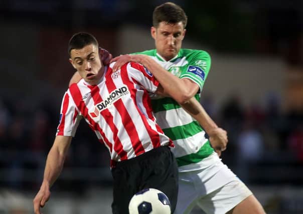 Derry City's Nathan Boyle shields the ball from Shamrock Rovers defender Jason McGuinness. Mandatory Credit Photo Lorcan Doherty/Presseye.com