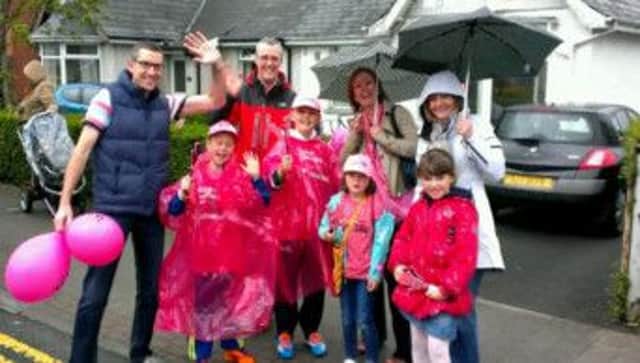 The Holland and McCallan families enjoying the Giro in Glengormley, despite the wet weather.
