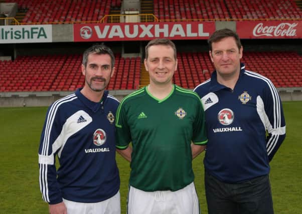 Liam Black from Ballymoney poses for a picture with forner NI internationals Keith Gillespie and Gerry Taggart at Windsor Park.
